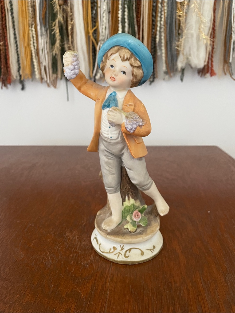 Blue-Hat Boy Figurine  holding grapes